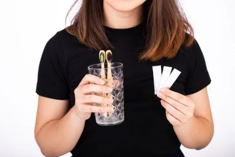 Choosing between brushing your teeth and chewing gum concept. Woman offering to Stock Photos