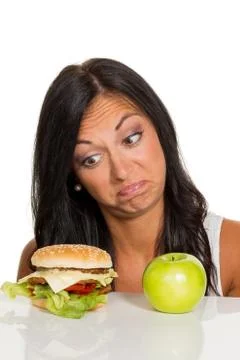 Choosing between hamburger and apple Stock Photos