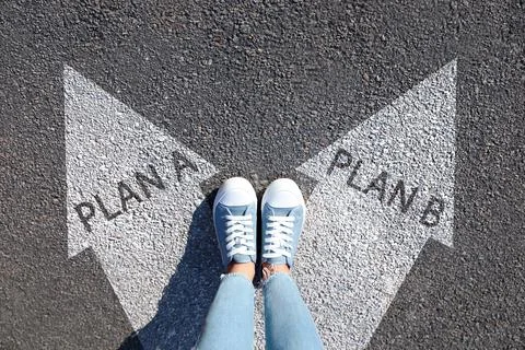 Choosing between Plan A and Plan B. Woman near arrows on road, above view Foto stock