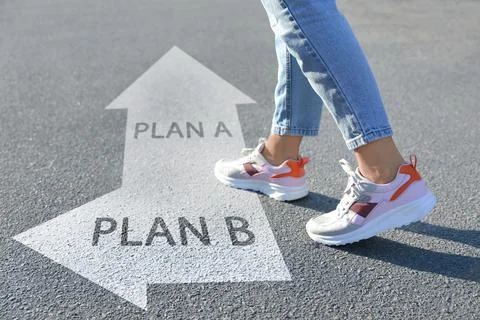 Choosing between Plan A and Plan B. Woman near pointers on road, closeup view Stock Photos