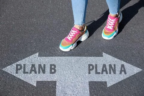 Choosing between Plan A and Plan B. Woman near pointers on road, closeup view Stock Photos
