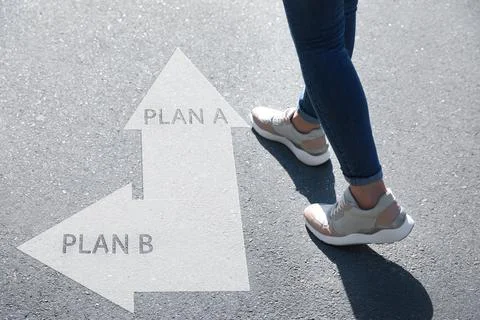 Choosing between Plan A and Plan B. Woman near pointers on road, closeup view Stock Photos