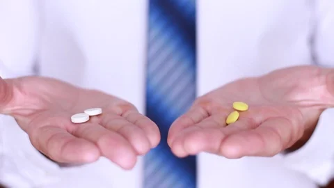Choosing between white and yellow pills Stock Footage 90442731