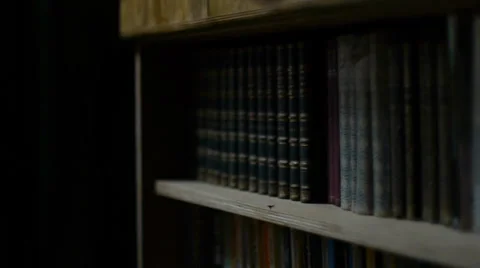 Choosing a book from shelve Stock Footage 36962446
