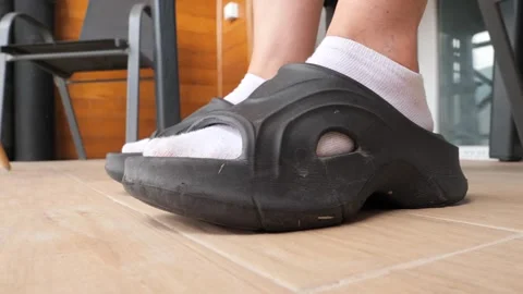 Choosing comfortable slide sandals for relaxing at home on a sunny day Stock-Footage 288380703