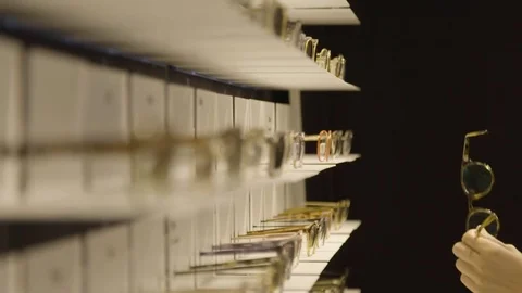 Choosing glasses in a shop Stock Footage 85224267