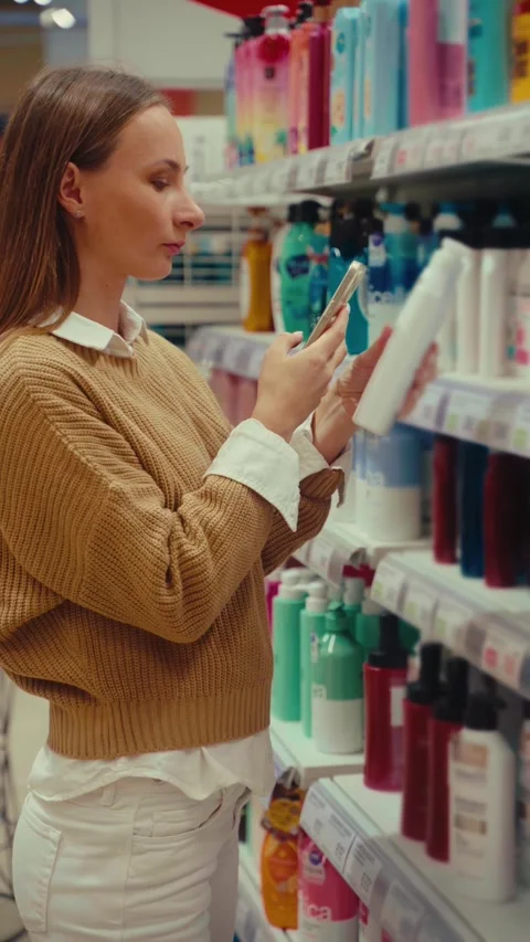 Choosing the perfect shower gel while shopping in a retail store Stock Footage 293674513