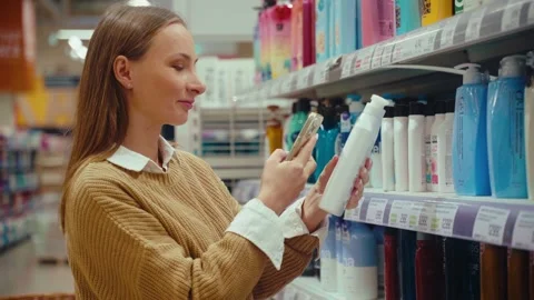 Choosing the perfect shower gel while shopping for personal care products in a Stock Footage 293675044