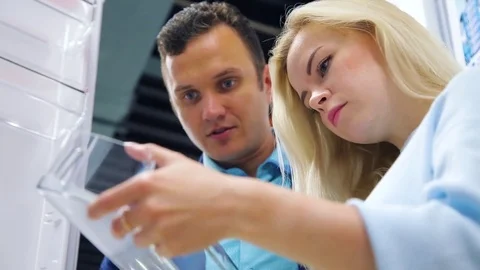 Choosing a refrigerator in the store Stock Footage 78099017