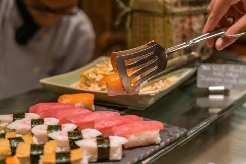 Choosing Salmon sushi in the buffet Foto stock