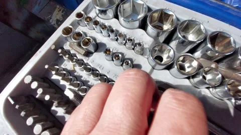Choosing a screwdriver bit from a professional tool box set Stock Footage 334569398