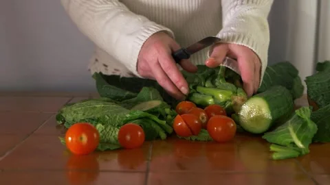 Choosing from a selection of fresh vegetables in the kitchen Video stock 152704714