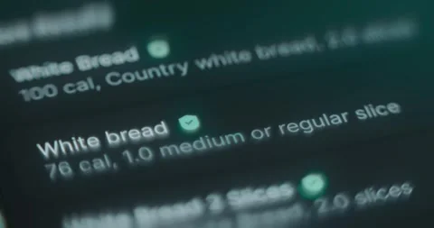 Choosing White Bread from the list of kinds of bread in calories tracker app 스톡 동영상 314879454