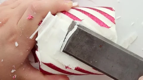 Chop a colored candle with a chisel. The wax cutting process. Close-up Stock Footage 281358379