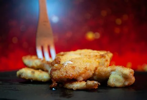 Chop with a fork on a black background Stock Photos