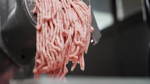 Chop the meat with an electric meat grinder in the kitchen. Minced chicken. Video stock 240169737