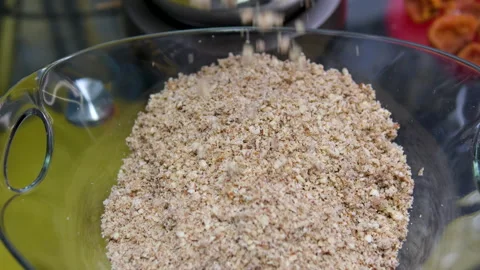 Chop the nuts grind nuts hazelnuts almonds in a meat grinder Stock Footage 302089453
