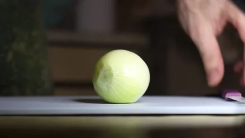 Chop onion with a ceramic knife, close-up Stock Footage 130769962