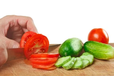 Chop tomatoes and cucumbers Stock Photos