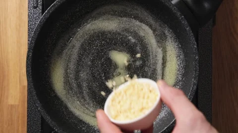 Chopped almonds are added to melted butter in frying pan. Stock Footage 342105392