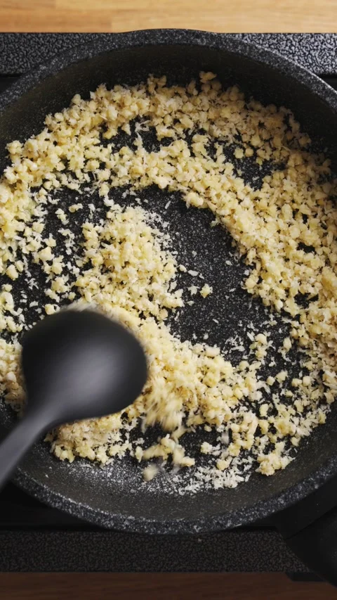 Chopped almonds mix with panko breadcrumbs in frying pan. Stock Footage 341314816