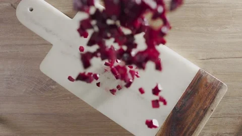 Chopped beet falls in slow motion to the rock board on the table falling vege Stock Footage 143780788