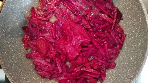 Chopped beets are fried in a pan. beetroot fried in a pan top view. Stock Footage 155684493
