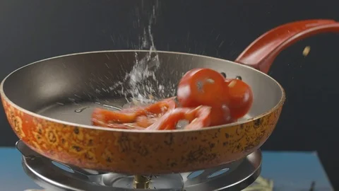 Chopped bell pepper slices falls into hot pan. Slow motion video 120fps Stock Footage 112220401