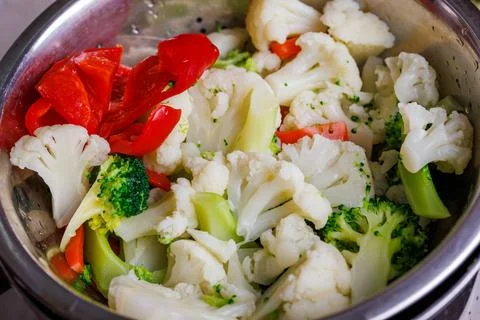 Chopped boiled vegetables in colander close-up full frame background Stock Photos