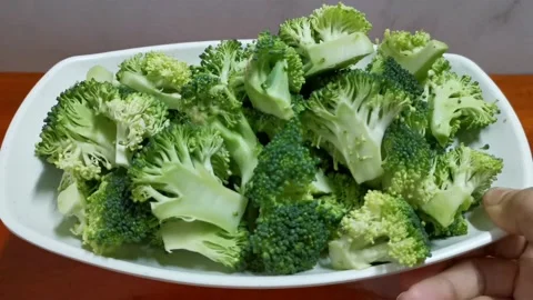 Chopped Broccoli Florets in a Plate Stock Footage 234882836