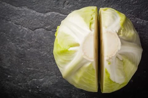 Chopped cabbage on a black stone background. Stock Photos