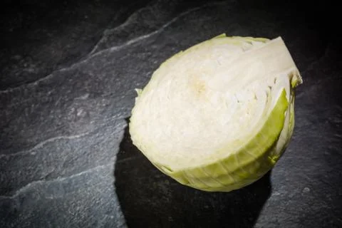 Chopped cabbage on a black stone background. Foto stock