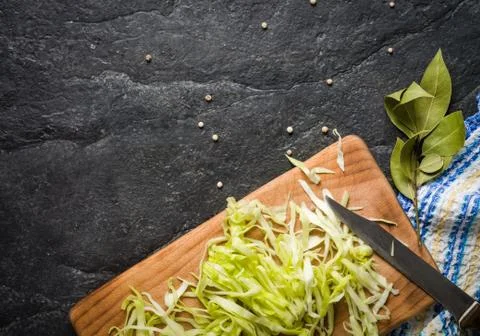 Chopped cabbage on a black stone background Stock Photos