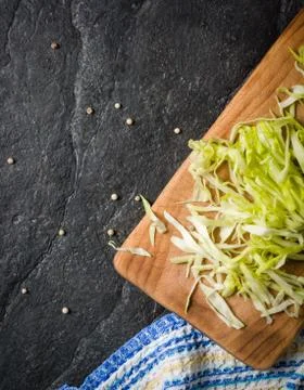 Chopped cabbage on a black stone background Stock Photos