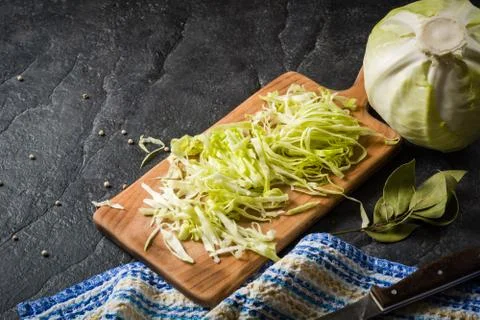 Chopped cabbage on a black stone background Stock Photos