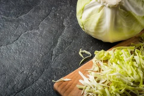 Chopped cabbage on a black stone background Stock-Fotos