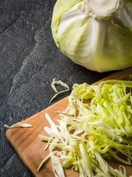 Chopped cabbage on a black stone background Stock Photos