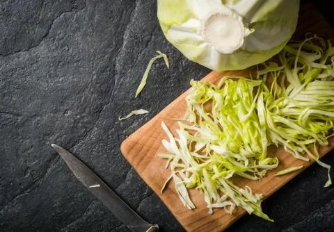 Chopped cabbage on a black stone background Stock Photos