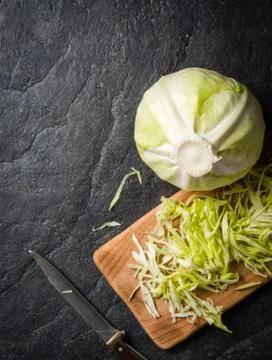 Chopped cabbage on a black stone background Stock Photos