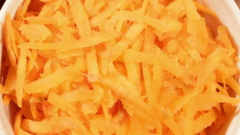 Chopped carrot and cabbage in white cup on wooden background close up. Stock Footage 74396977