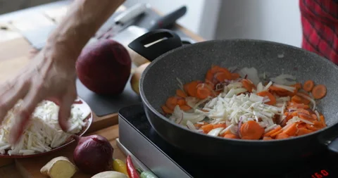 Chopped celery root added into cooking pan Stock Footage 146246320