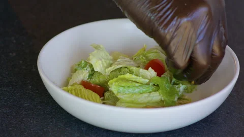 Chopped cherry tomatoes are added with lettuce leaves Stock Footage 158782213