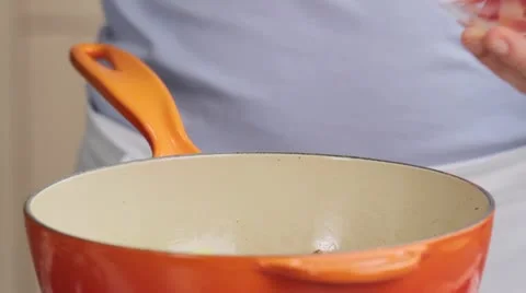 Chopped courgette being added to a pan and seasoned salt 스톡 동영상 24656850