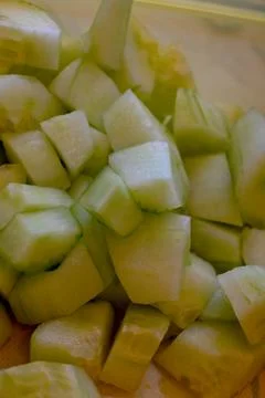 Chopped cucumber cubes close-up Stock Photos