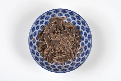 Chopped dark chocolate in a blue patterned bowl Stock Photos
