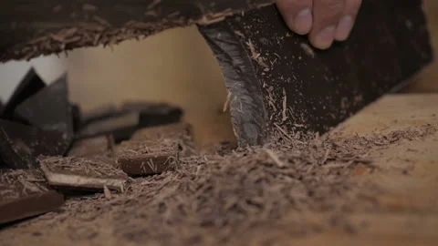 Chopped dark chocolate on kitchen board. Chopping a Bar of Chocolate while Ma Stock Footage 121135978