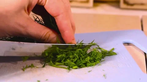 Chopped dill hands on the home kitchen blue board, cut, chop Stock Footage 62191792