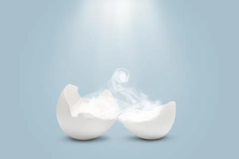 Chopped egg with smoke inside and light rays above Stock Photos