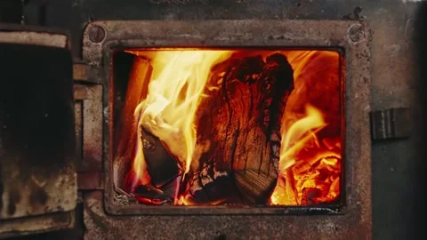 Chopped Firewood Burning Inside Rusty Stove - Fire Through Open Door Stock Footage 327988253