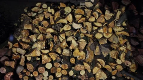 Chopped firewood, wood background, falling snow. Preparation for the winter Stock Footage 263965341
